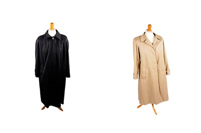 Lot 741 - An Aquascutum navy blue trench coat; and an Aquascutum camel trench coat