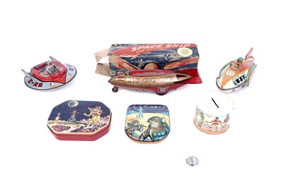 Lot 285 - Tinplate space toys; and a Gamages Club badge