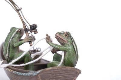 Lot 733 - A cold painted bronze group of two frogs in a fishing boat