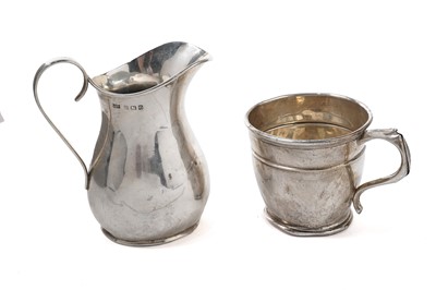 Lot 1069 - A George V silver cream jug; and a silver mug