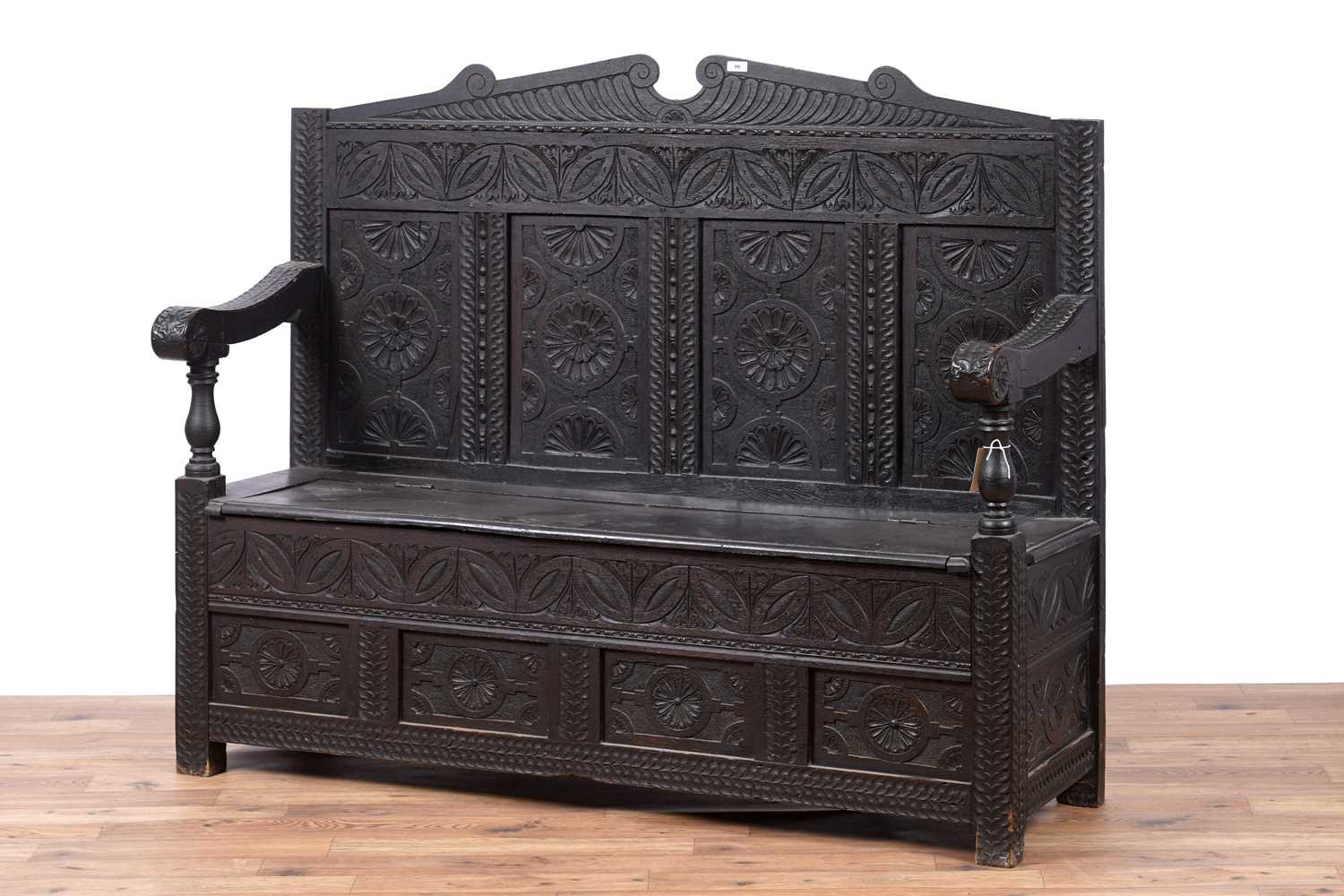 Lot 96 - A Georgian oak box settle