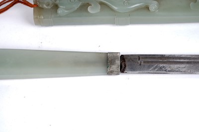 Lot 877 - A Chinese carved jade dagger and sheath; and a carved jade medallion