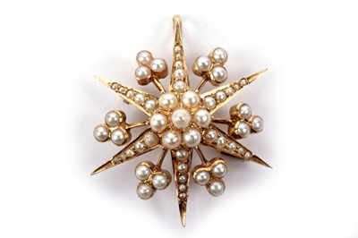 Lot 779 - An Edwardian half-pearl star brooch