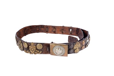 Lot 168 - A German WWI belt with buckle mounted by British cap badges