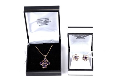 Lot 210A - An amethyst cluster pendant; and a pair of amethyst flower pattern stud earrings