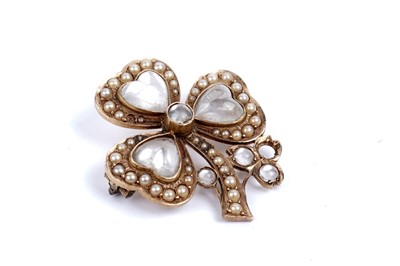 Lot 612 - An Edwardian moonstone and seed pearl shamrock pattern brooch