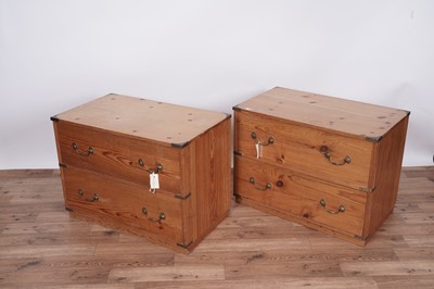 Lot 119 - A pair of campaign style pine bedside drawers