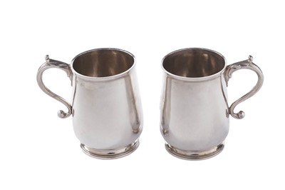 Lot 134 - A pair of George II Irish provincial silver mugs; and a scratch-weight