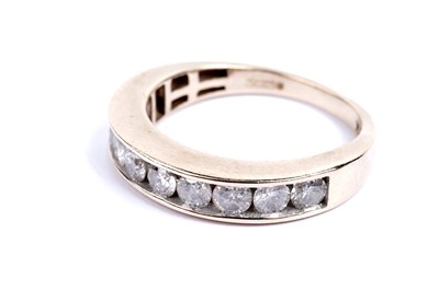 Lot 642 - A diamond half hoop eternity ring