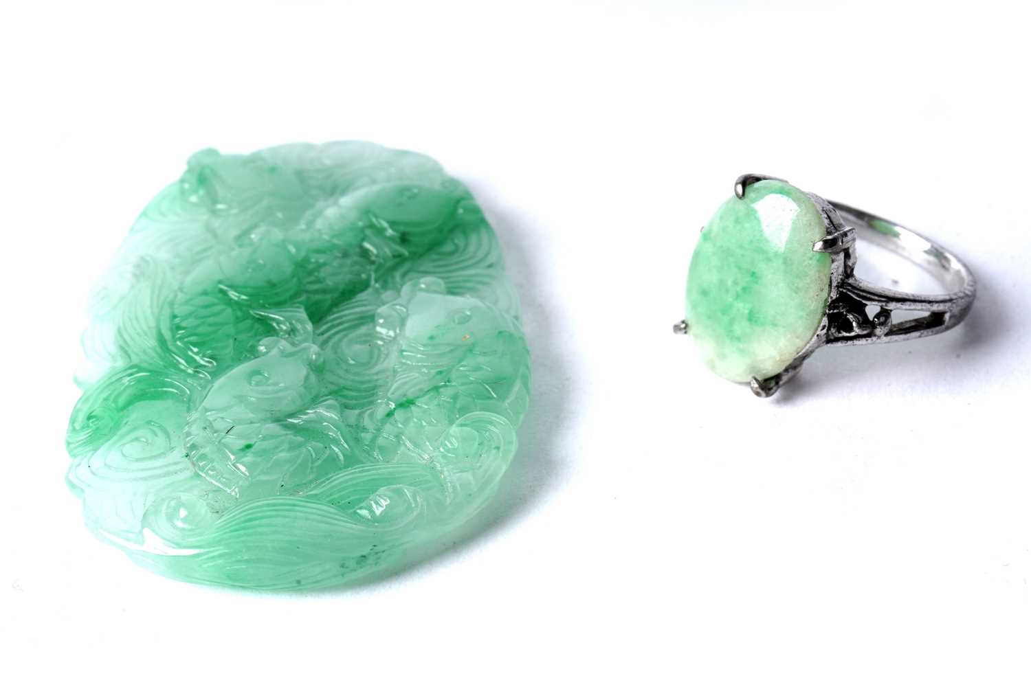 Lot 83 - A carved jadeite pendant; and a jadeite cabochon ring