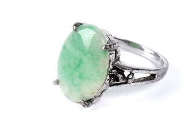 Lot 83 - A carved jadeite pendant; and a jadeite cabochon ring