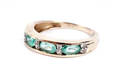 Lot 110 - A Colombian emerald and white zircon half hoop eternity ring