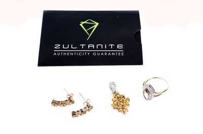 Lot 121 - A fancy yellow sapphire and white stone cluster pendant and earrings; and a cluster dress ring