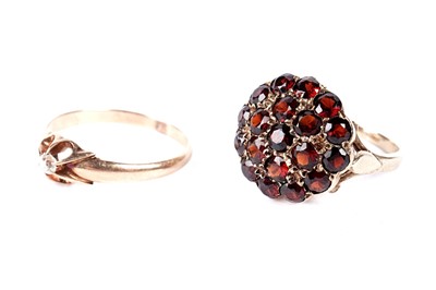 Lot 240 - A diamond ring and a garnet ring