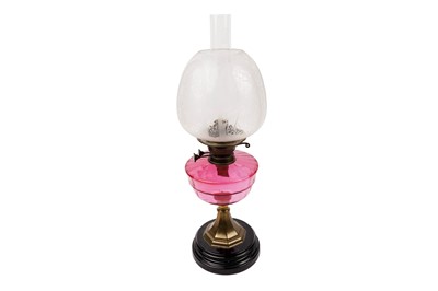 Lot 205 - ﻿A late Victorian oil lamp with cranberry glass reserve