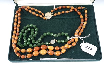 Lot 274 - A butterscotch amber bead two strand necklace; and a bowenite bead necklace