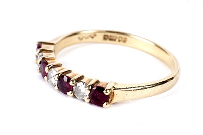 Lot 290 - A ruby and diamond half eternity ring