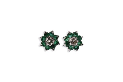 Lot 686 - A pair of emerald and diamond cluster earrings