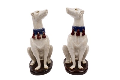 Lot 342 - ﻿A pair of faience style decorative ceramic dogs modelled as greyhounds