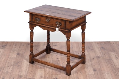 Lot 84 - Attributed to Theodore Alexander: a Georgian style oak side table