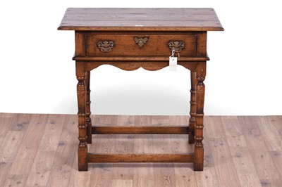 Lot 84 - Attributed to Theodore Alexander: a Georgian style oak side table