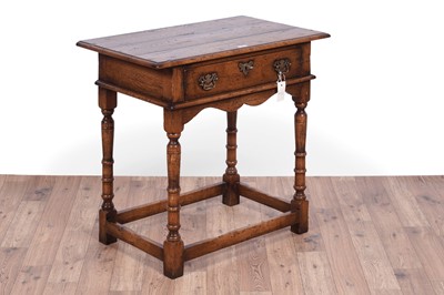 Lot 84 - Attributed to Theodore Alexander: a Georgian style oak side table