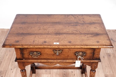 Lot 84 - Attributed to Theodore Alexander: a Georgian style oak side table