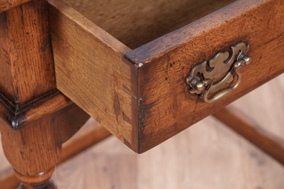 Lot 84 - Attributed to Theodore Alexander: a Georgian style oak side table