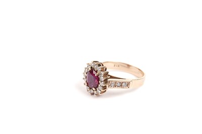 Lot 808 - A ruby and diamond cluster ring