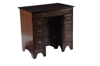 Lot 65 - A George III oak kneehole desk