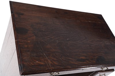 Lot 65 - A George III oak kneehole desk