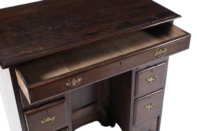Lot 65 - A George III oak kneehole desk