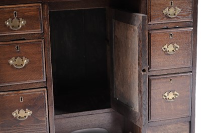 Lot 65 - A George III oak kneehole desk