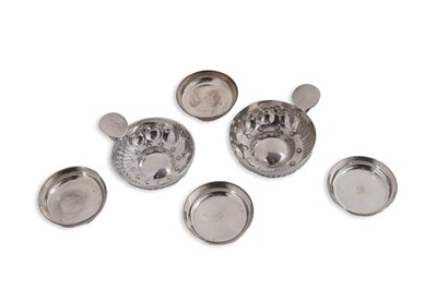 Lot 69 - Two late 19th/early 20th century French wine tasters; and a set of four small silver dishes