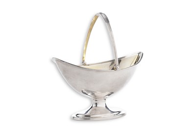 Lot 77 - A George III silver swing-handled sugar basket