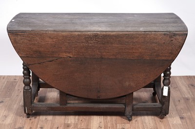 Lot 104 - An 18th Century oak drop-leaf dining table; and other items
