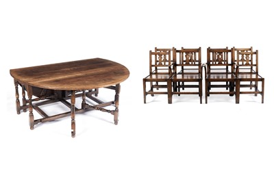 Lot 1450 - A Titchmarsh and Goodwin large oak drop leaf table with eight dining chairs