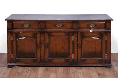 Lot 115 - Titchmarsh and Goodwin: a Georgian style oak sideboard