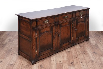 Lot 115 - Titchmarsh and Goodwin: a Georgian style oak sideboard