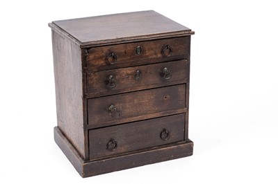 Lot 257 - A George III oak miniature chest of drawers