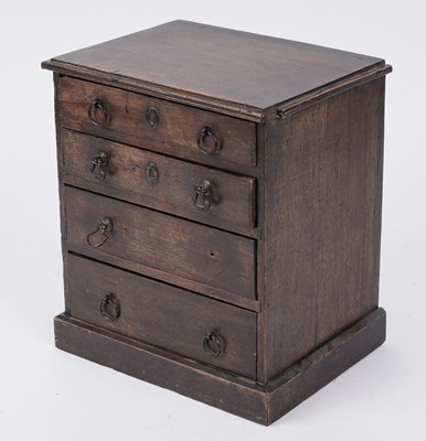 Lot 257 - A George III oak miniature chest of drawers