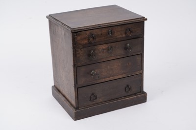 Lot 257 - A George III oak miniature chest of drawers