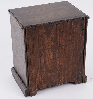 Lot 257 - A George III oak miniature chest of drawers