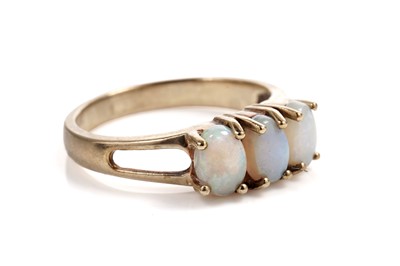 Lot 606 - An opal three stone dress ring