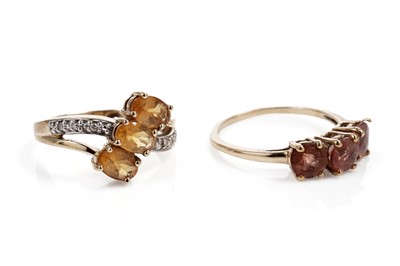 Lot 613 - A citrine and diamond dress ring; a three stone dress ring