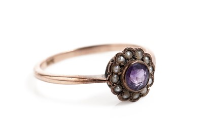 Lot 681 - An Edwardian amethyst and seed pearl cluster ring