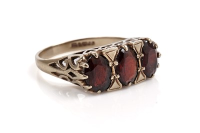 Lot 704 - A garnet three stone ring