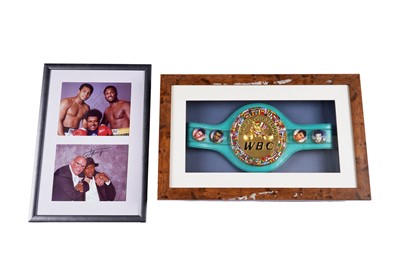 Lot 205 - Two framed Joe Frazier photographs; and a framed Joe Frazier replica belt