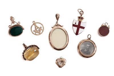 Lot 97 - A selection of gold mounted charms and fobs