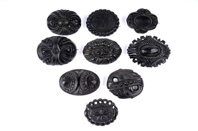 Lot 1492 - Nine Victorian Etruscan revival jet and faux jet brooches